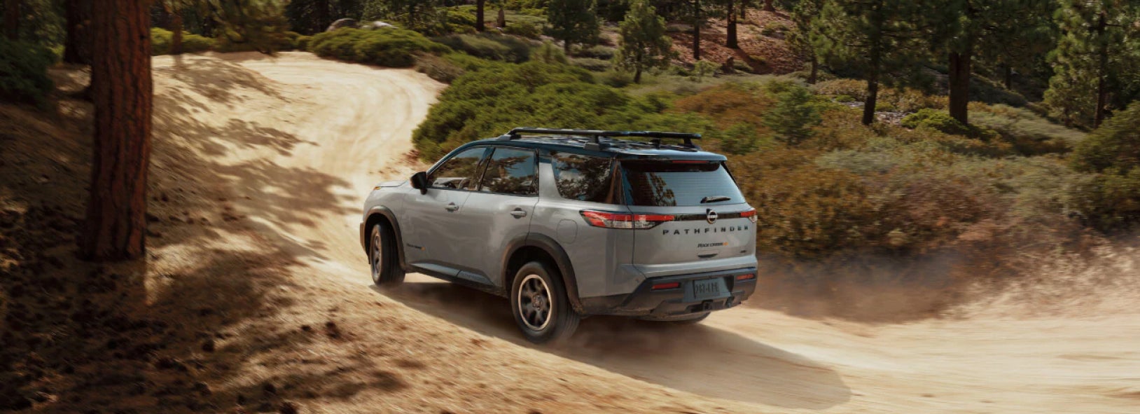 Nissan SUV driving on a dirt road