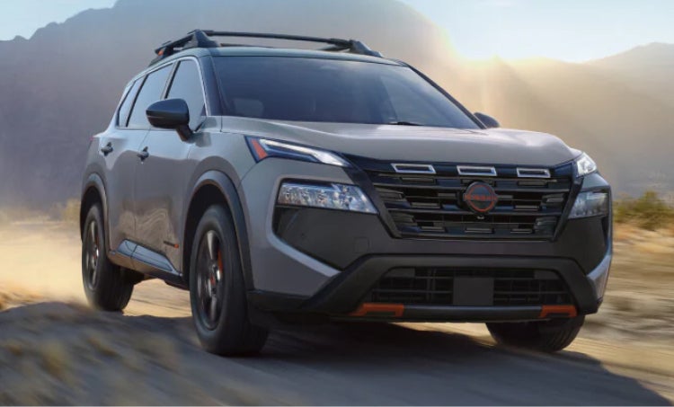 Nissa n SUV driving through the desert highway